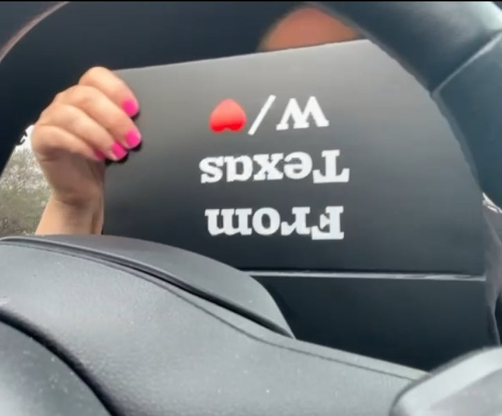 Customer unboxing the From Texas W/❤️ Empowerment Pack inside a car, showcasing packaging and product reveal moment.