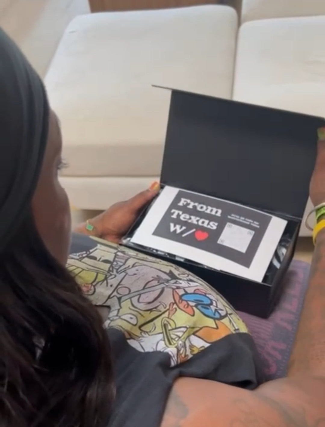 Customer unboxing the From Texas W/❤️ Empowerment Pack, showing training tools and branded gear inside the box.