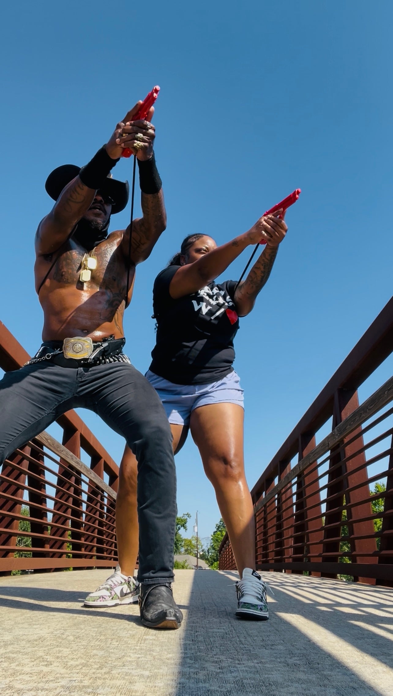 Man and woman training with GRUPS® Grip Trainer on a bridge in Texas, practicing grip strength and self-defense together.