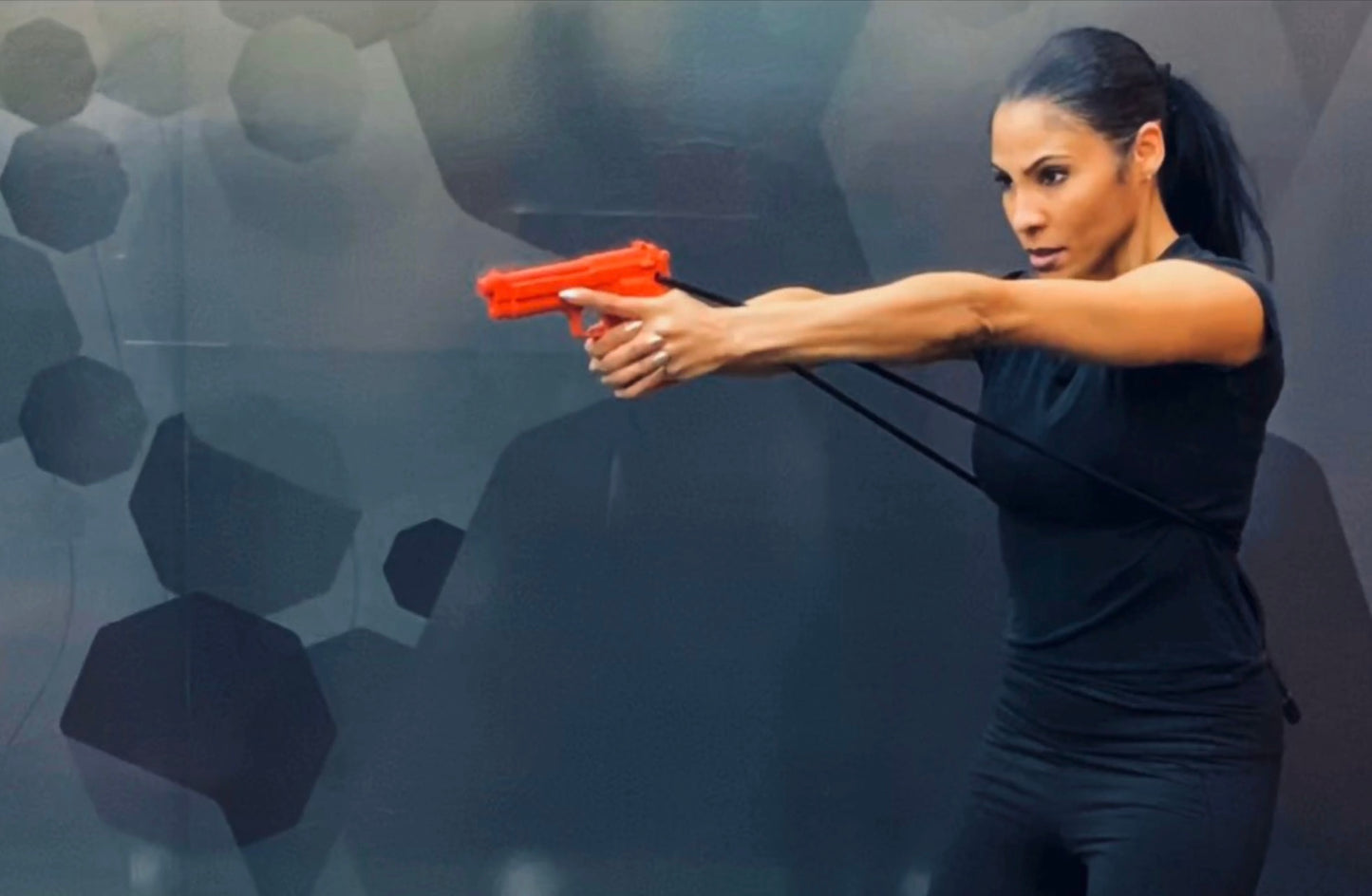 Woman training with GRUPS® Grip Trainer for strength, self-defense, and fitness practice indoors.
